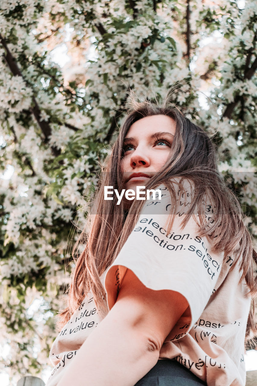 Portrait of woman against plants