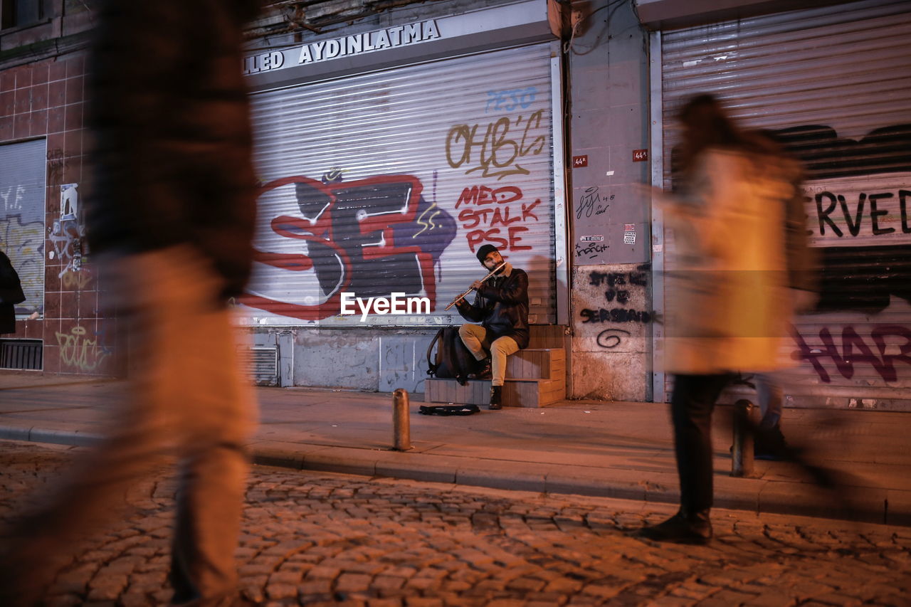 BLURRED MOTION OF PEOPLE WALKING ON STREET