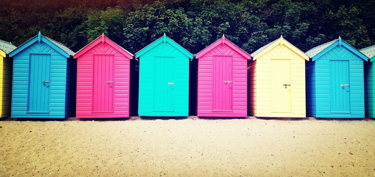 Multi colored beach huts on beach