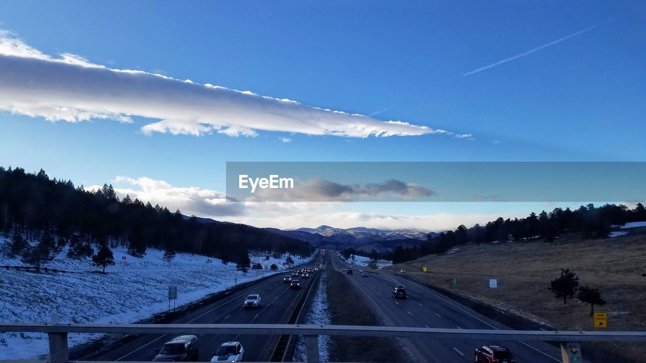ROAD AMIDST TREES AGAINST SKY