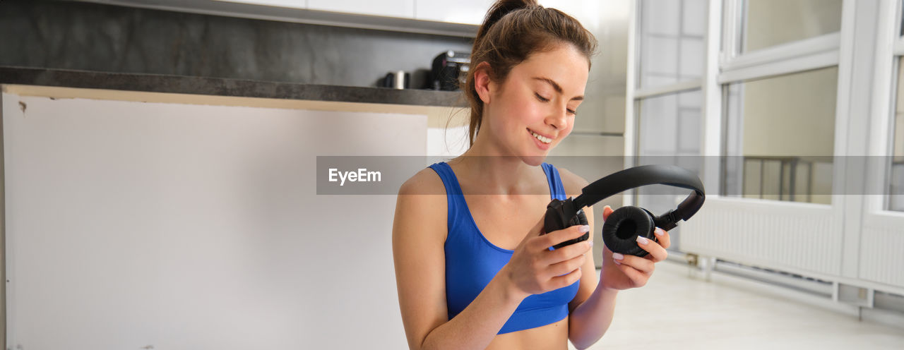 side view of woman exercising in gym at home