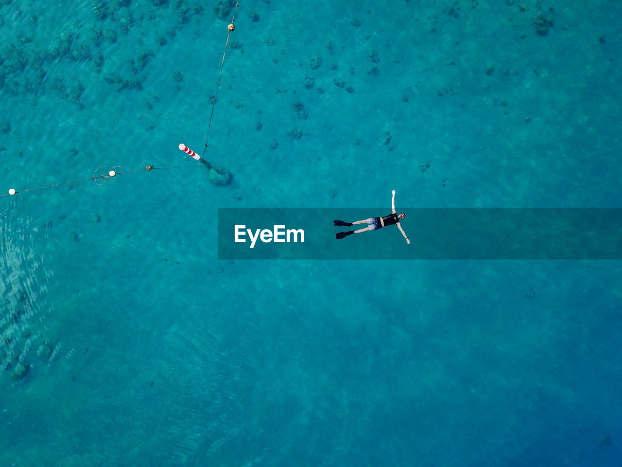 Aerial view of person floating in sea
