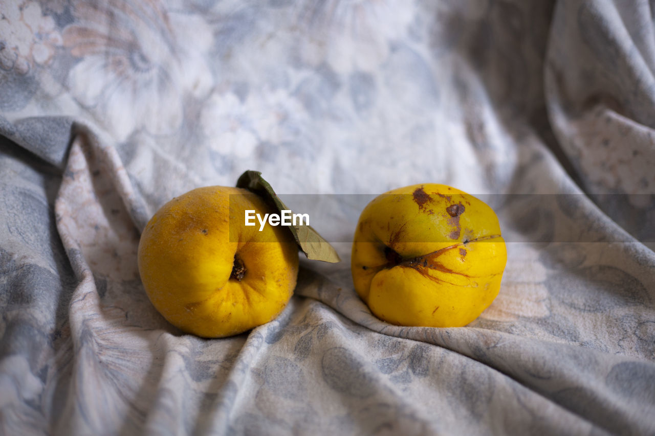 HIGH ANGLE VIEW OF YELLOW FRUITS ON TABLE