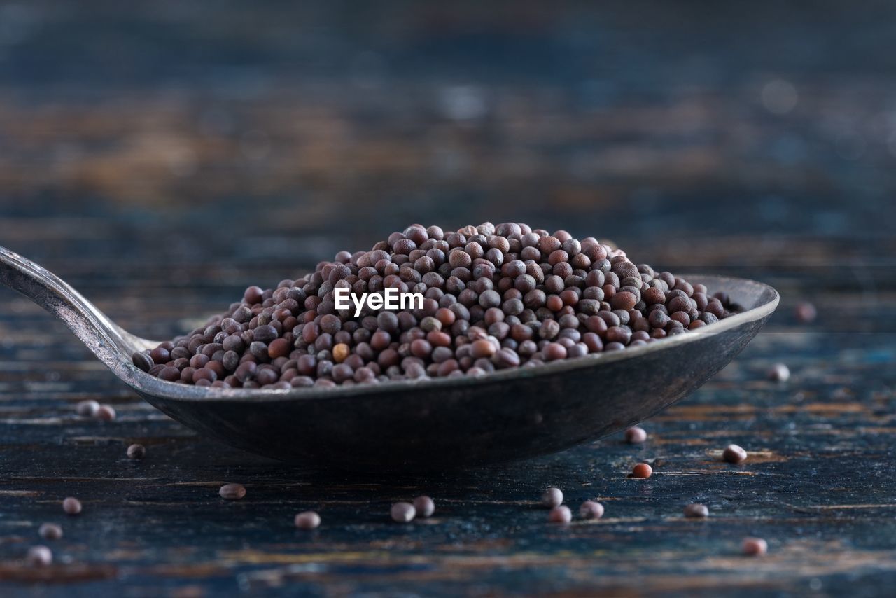 Close-up of seeds in spoon on table