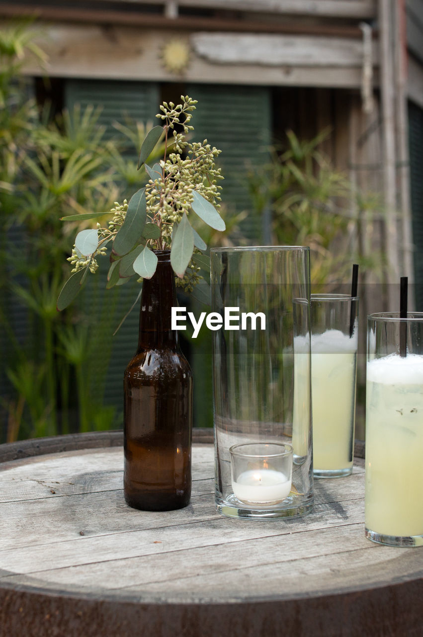 Close-up of drink glasses with candle on table