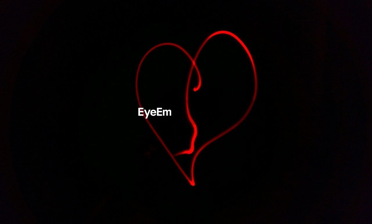 CLOSE-UP OF RED HEART SHAPE AGAINST BLACK BACKGROUND