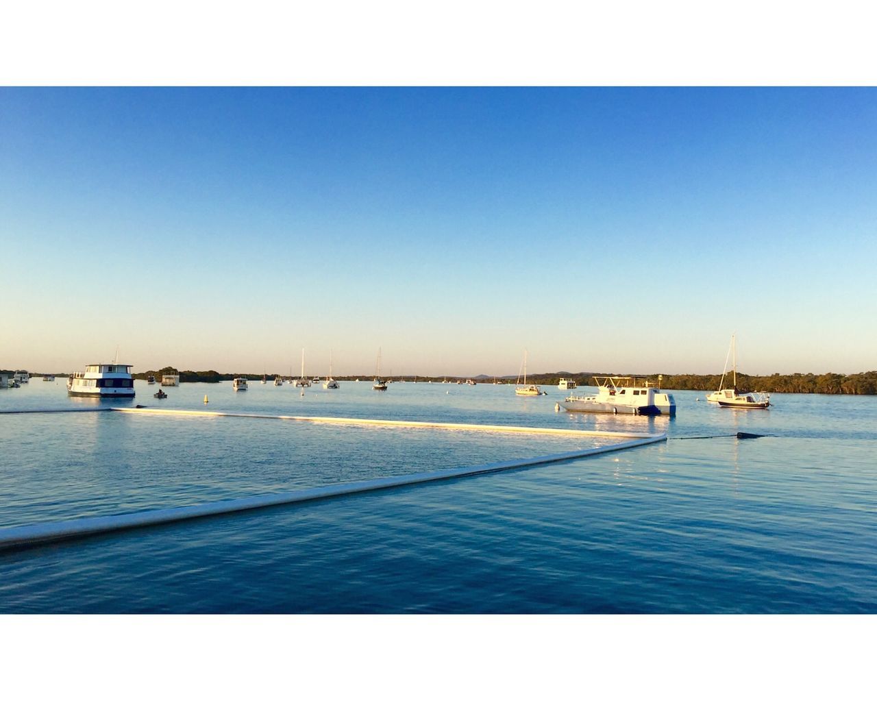 BOATS MOORED IN SEA