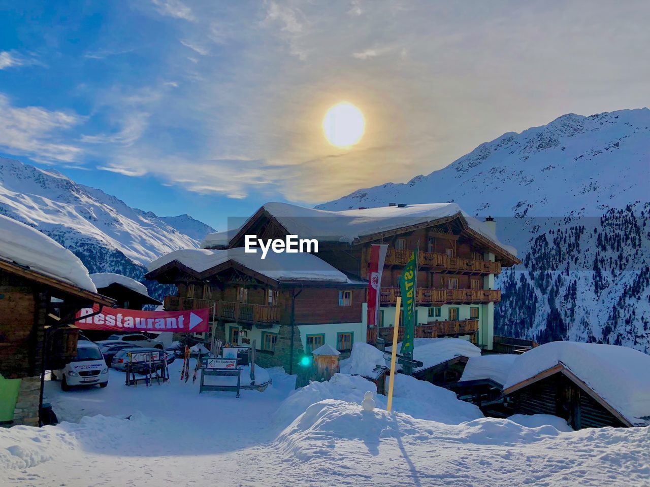 HOUSES AGAINST SNOWCAPPED MOUNTAINS DURING WINTER