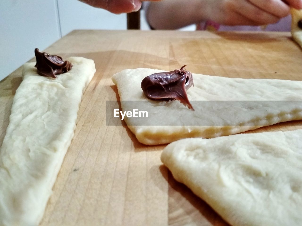 CLOSE-UP OF HAND FEEDING FOOD