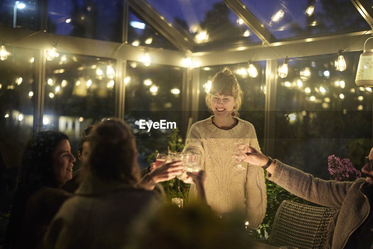 Friends having evening meal together