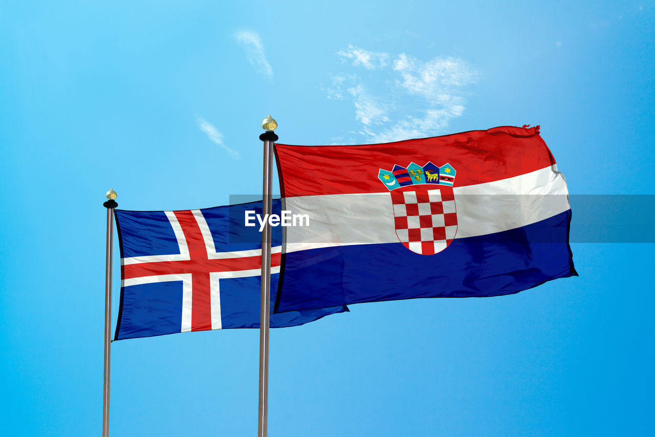 Flags against blue sky