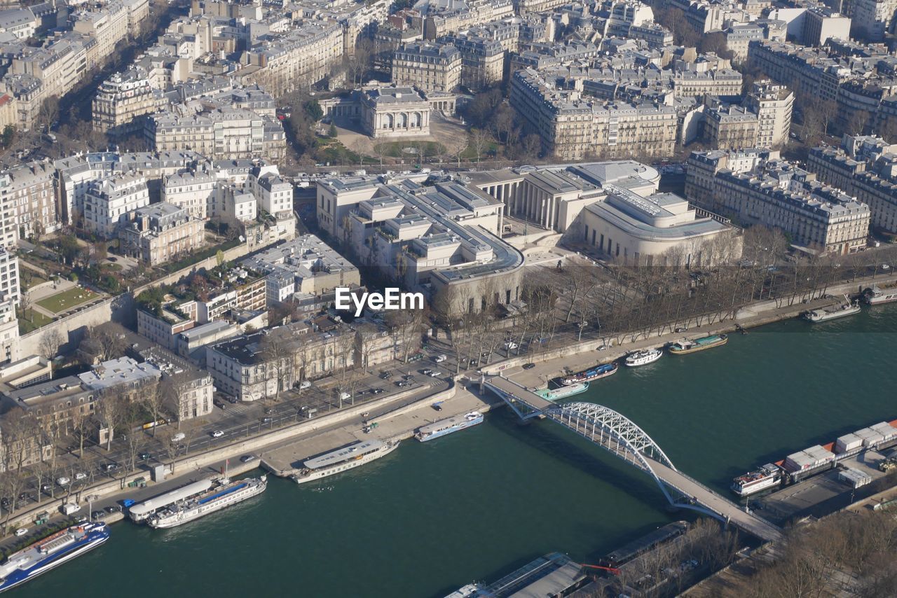 HIGH ANGLE VIEW OF RIVER AMIDST BUILDINGS