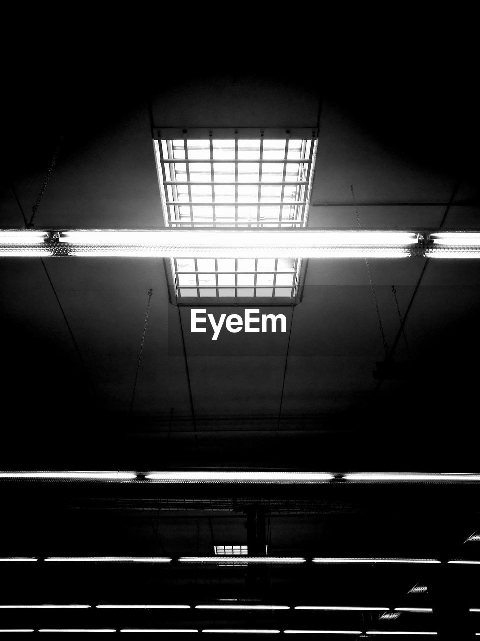 LOW ANGLE VIEW OF ILLUMINATED SKYLIGHT