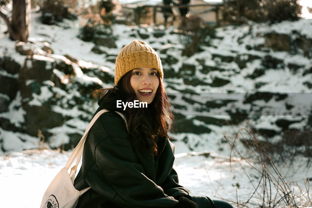 Portrait of smiling young woman in snow