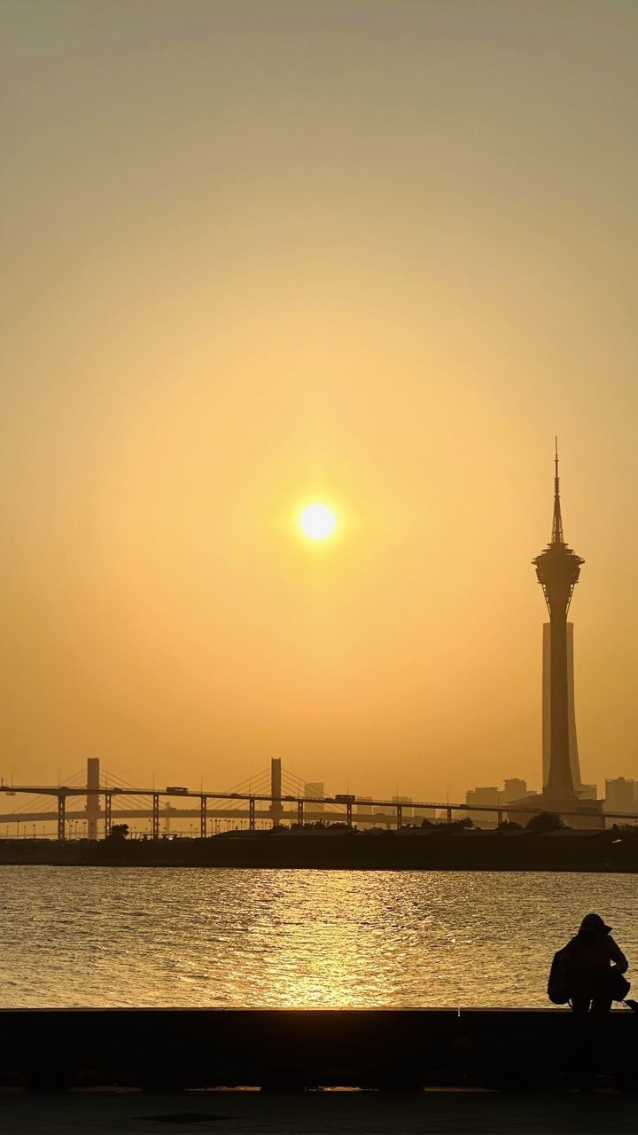 sky, sunset, water, architecture, sea, dawn, built structure, silhouette, nature, horizon, travel destinations, sun, evening, beauty in nature, tower, travel, building exterior, afterglow, sunlight, orange color, transportation, lighthouse, scenics - nature, reflection, tranquility, city, tourism, nautical vessel, no people, building, outdoors, ocean, beach, tranquil scene, idyllic, back lit, coast, pier