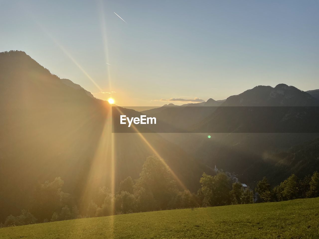 SCENIC VIEW OF MOUNTAINS AGAINST BRIGHT SUN