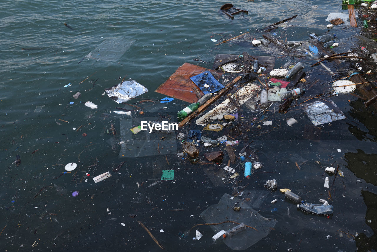 HIGH ANGLE VIEW OF GARBAGE IN RIVER