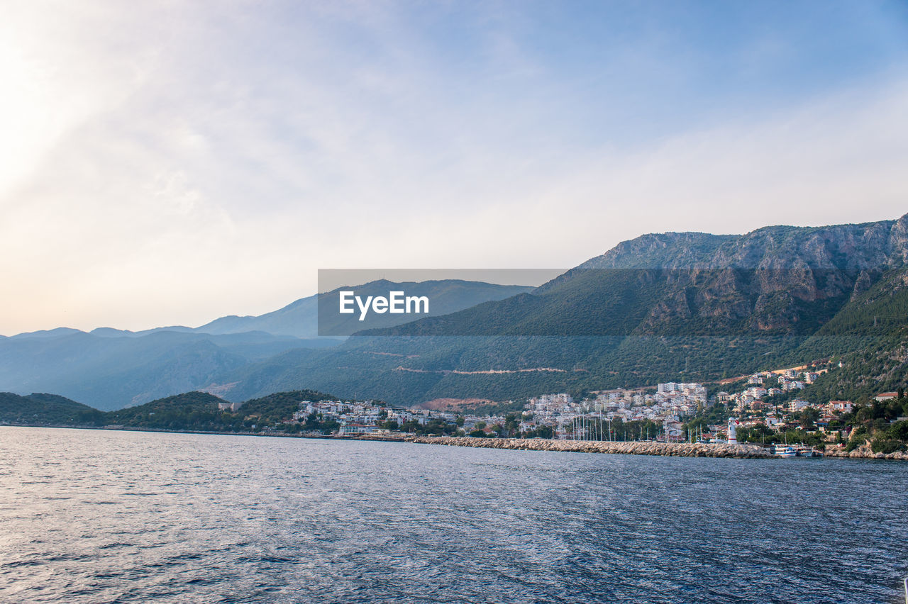 Scenic view of river and mountains against sky