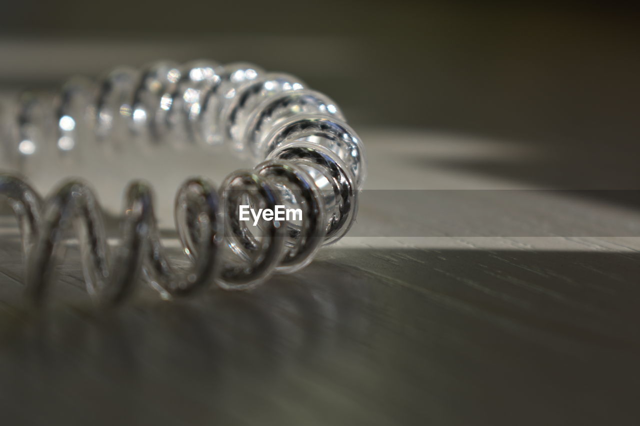 CLOSE-UP OF WEDDING RINGS ON METAL TABLE