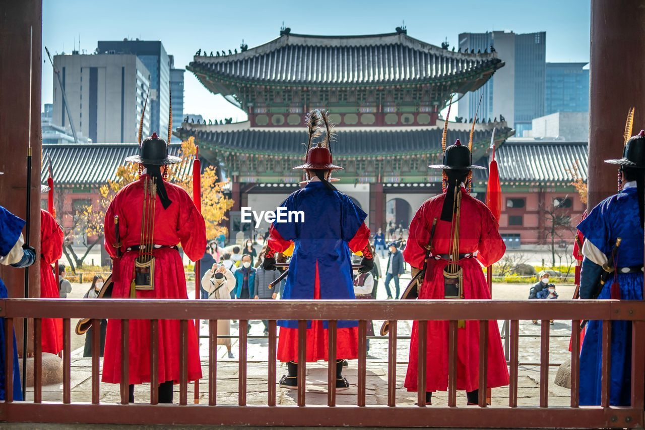 architecture, group of people, built structure, building exterior, history, travel destinations, the past, city, men, clothing, building, tradition, adult, travel, person, nature, outdoors, religion, day, temple, tourism, railing