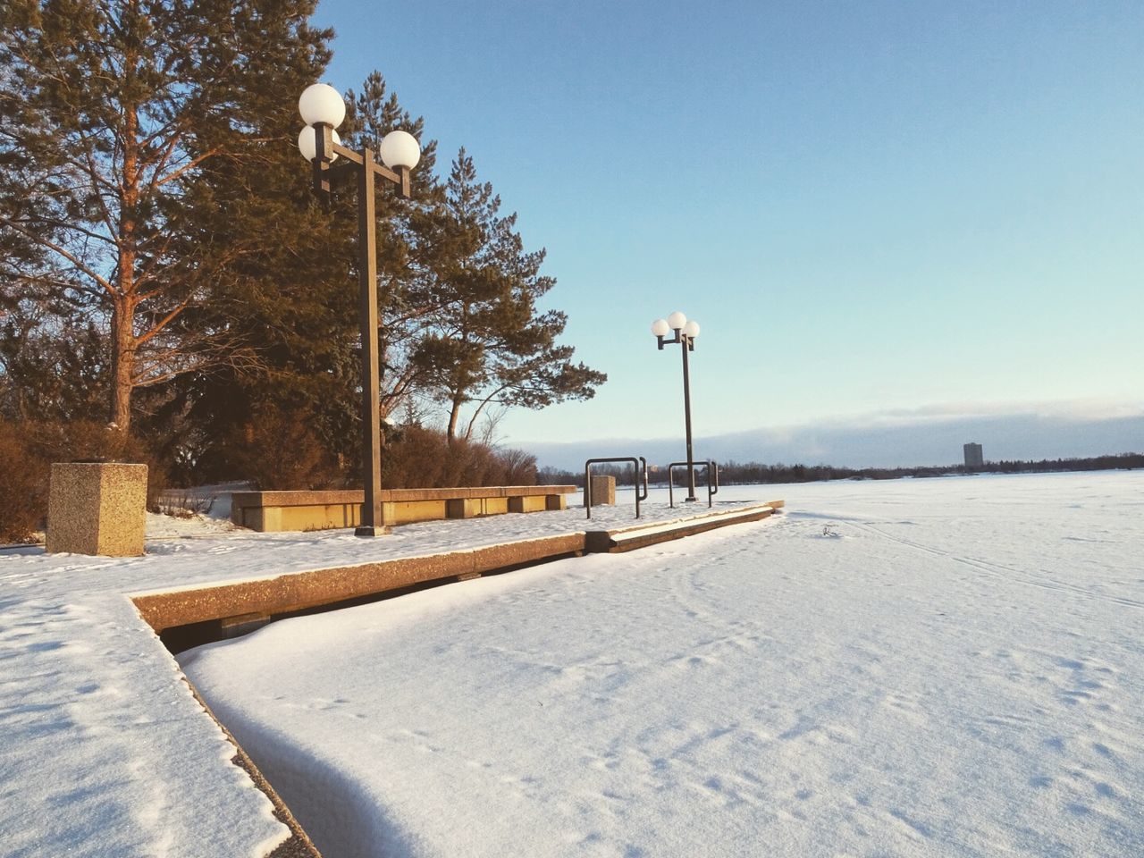 Frozen lake and pier against sky