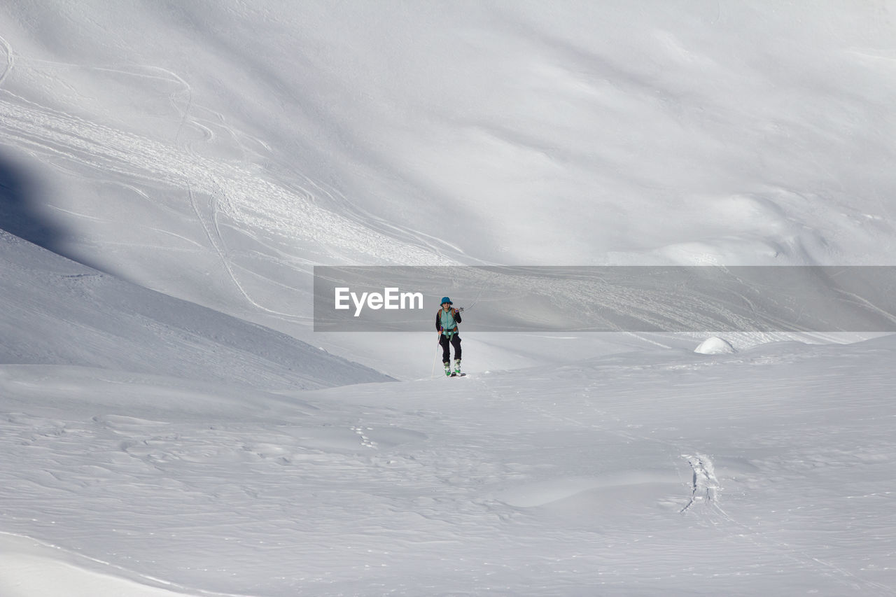 Woman skiing on snowcapped mountain 