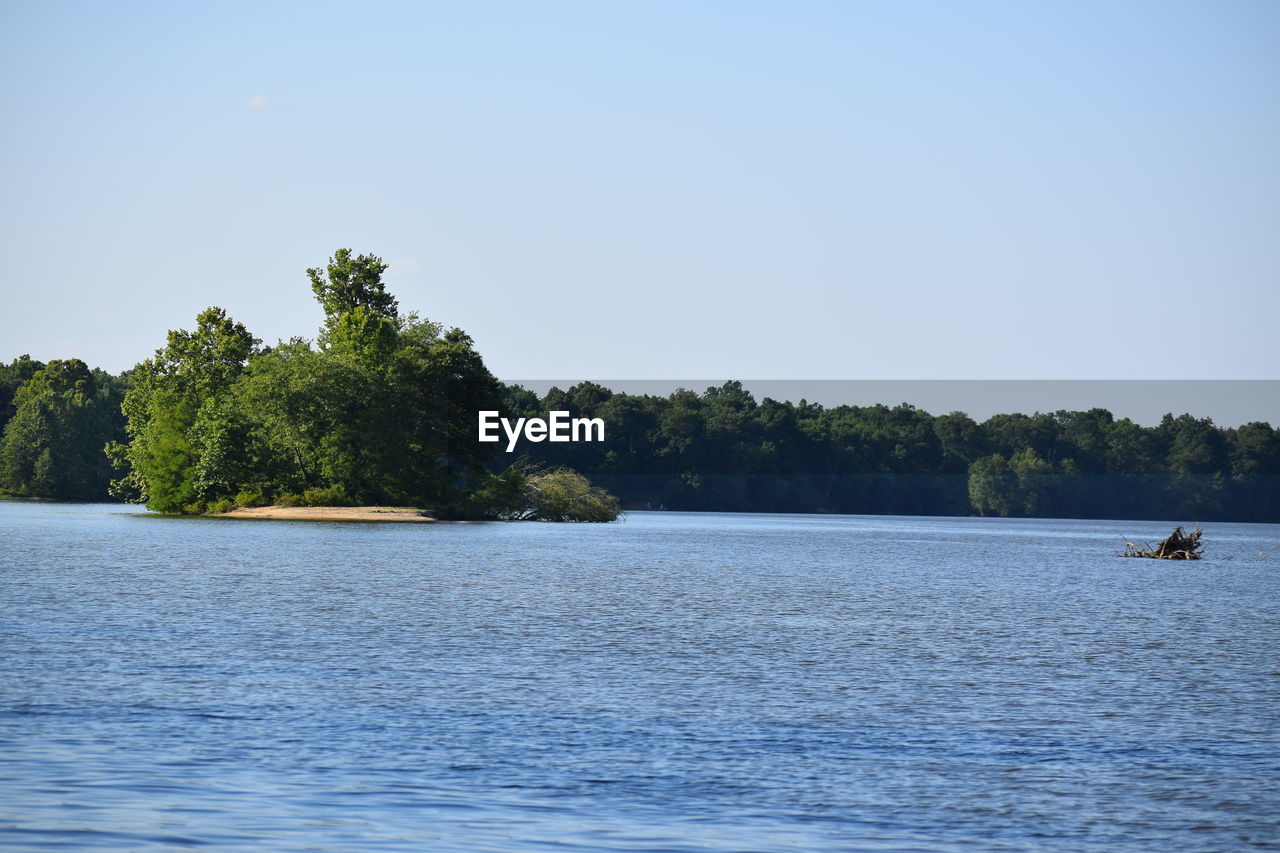 Scenic view of calm lake against clear sky