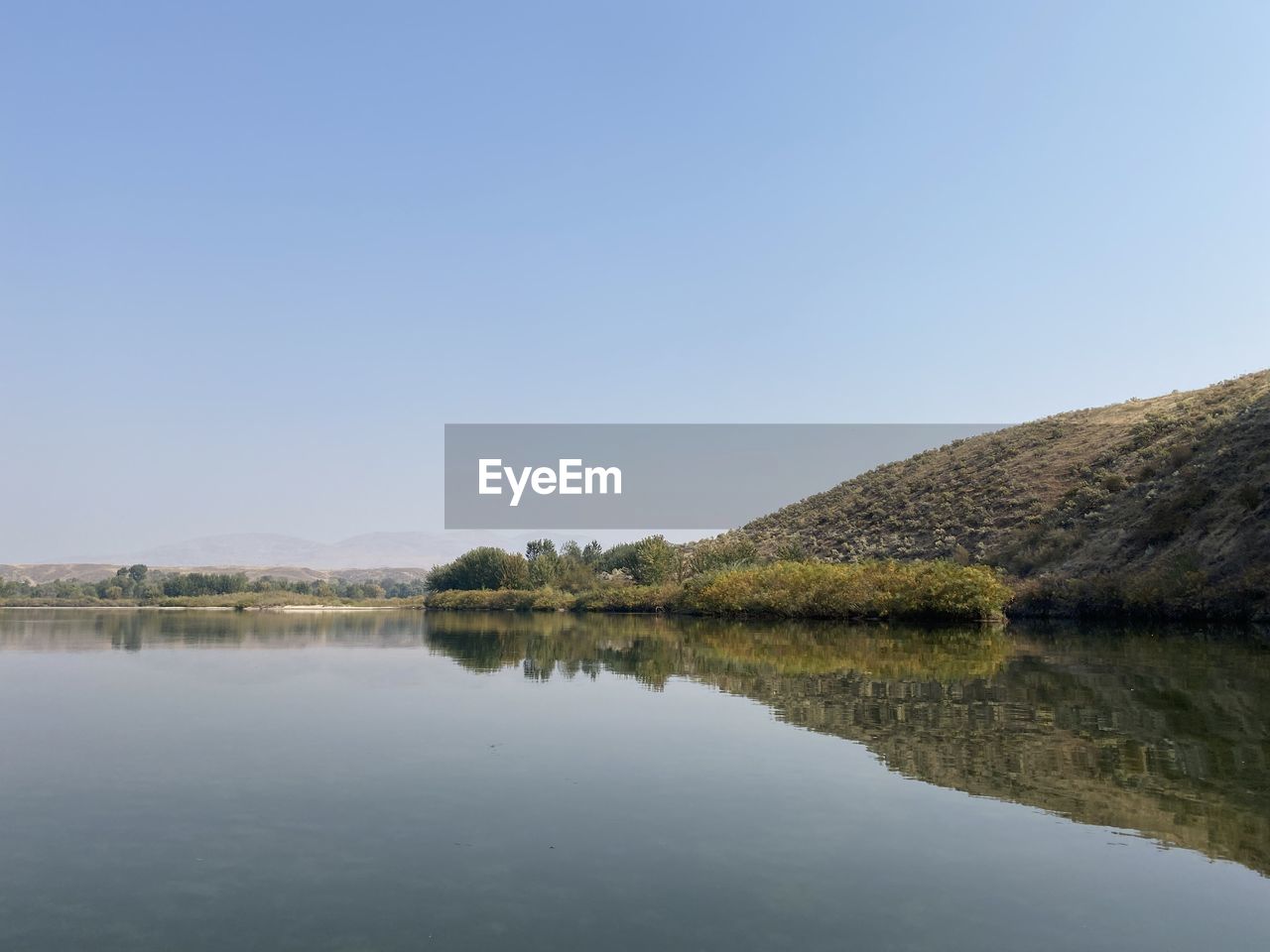 SCENIC VIEW OF LAKE AGAINST BLUE SKY