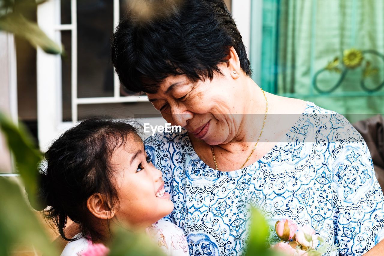 Smiling grandmother and daughter at home