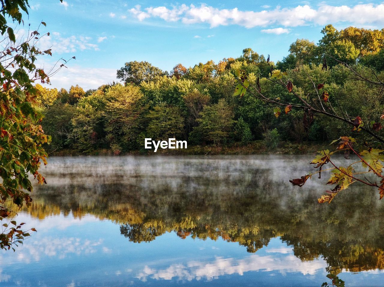 Reflection of trees in lake against sky during autumn