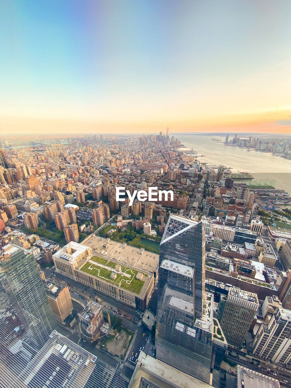 High angle view of city buildings against sky during sunset