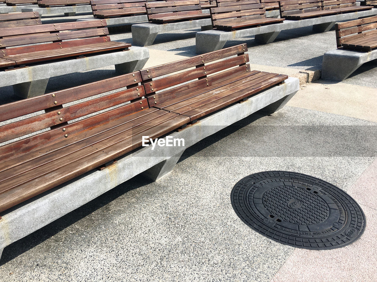 High angle view of empty benches on footpath