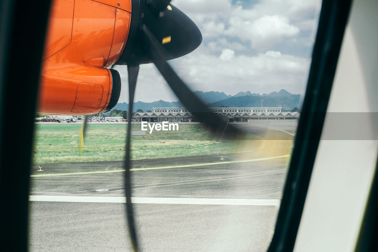 View of airport seen through airplane window