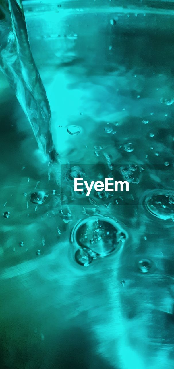 CLOSE-UP OF WATER DROPS IN SWIMMING POOL