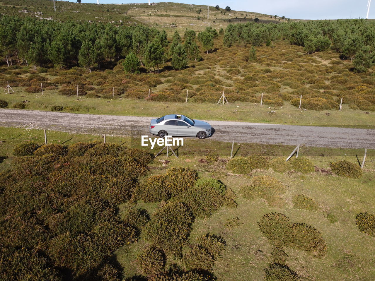 VIEW OF CAR ON ROAD ALONG LANDSCAPE