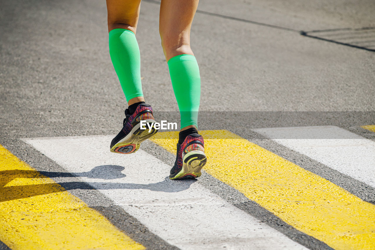 Legs girl runner in bright green compression socks