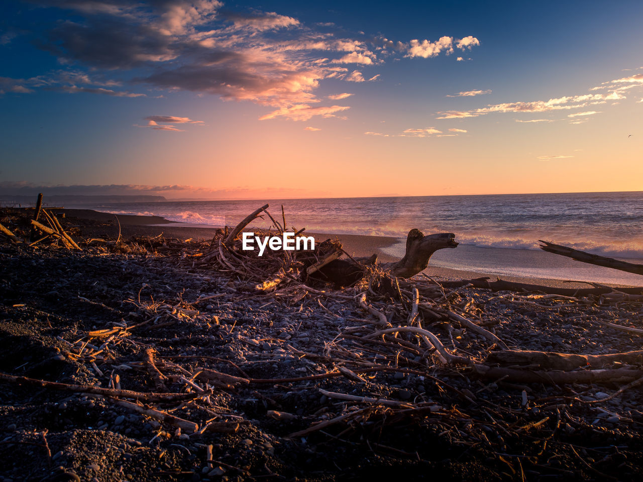 Scenic view of sea against sky at sunset