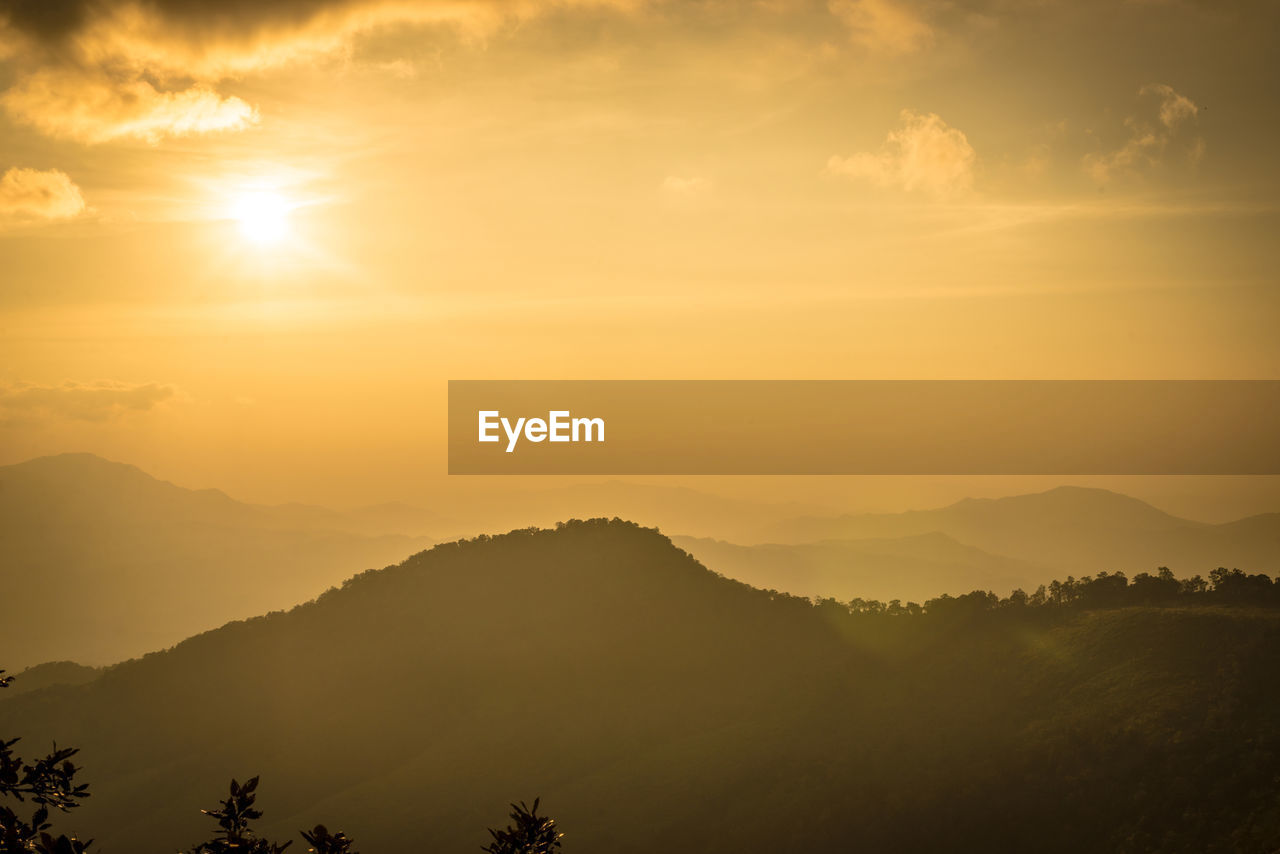 Scenic view of silhouette mountains against sky during sunset