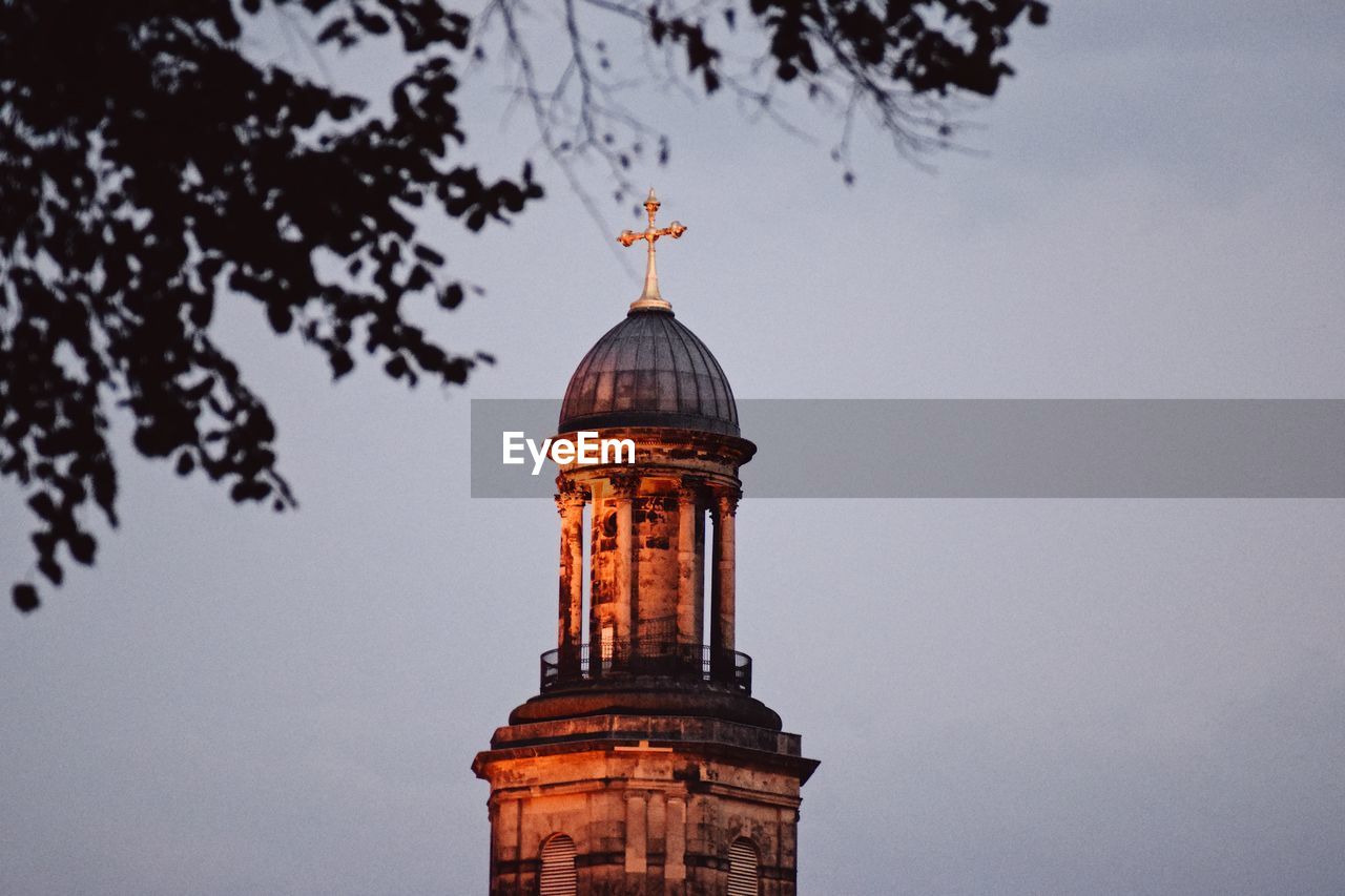 Low angle view of bell tower against sky