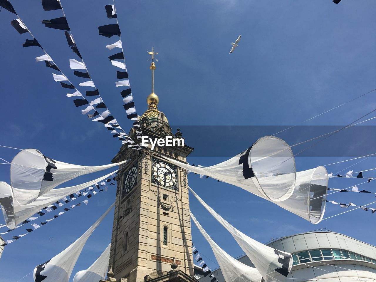 Low angle view of decorated clock tower against sky