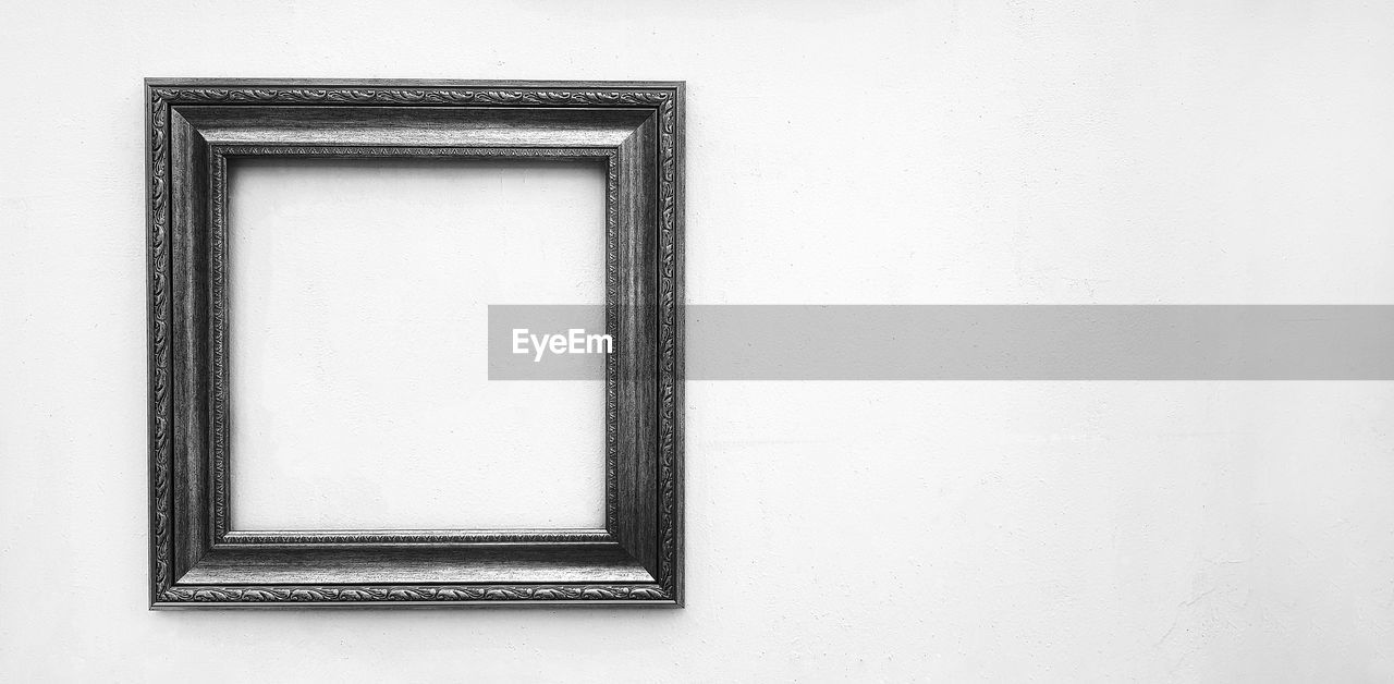 picture frame, wall - building feature, frame, copy space, white, architecture, indoors, no people, built structure, shape, rectangle, window, pattern, black and white, geometric shape