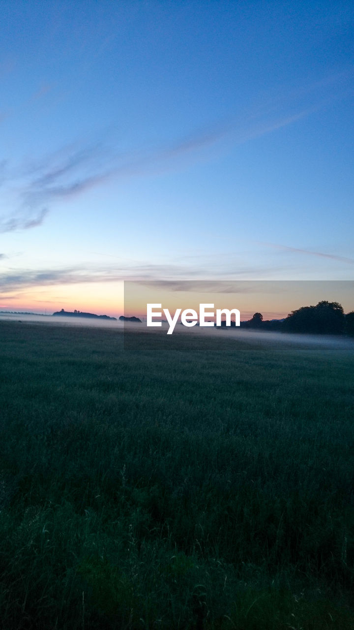 SCENIC VIEW OF LANDSCAPE AGAINST SKY DURING SUNSET