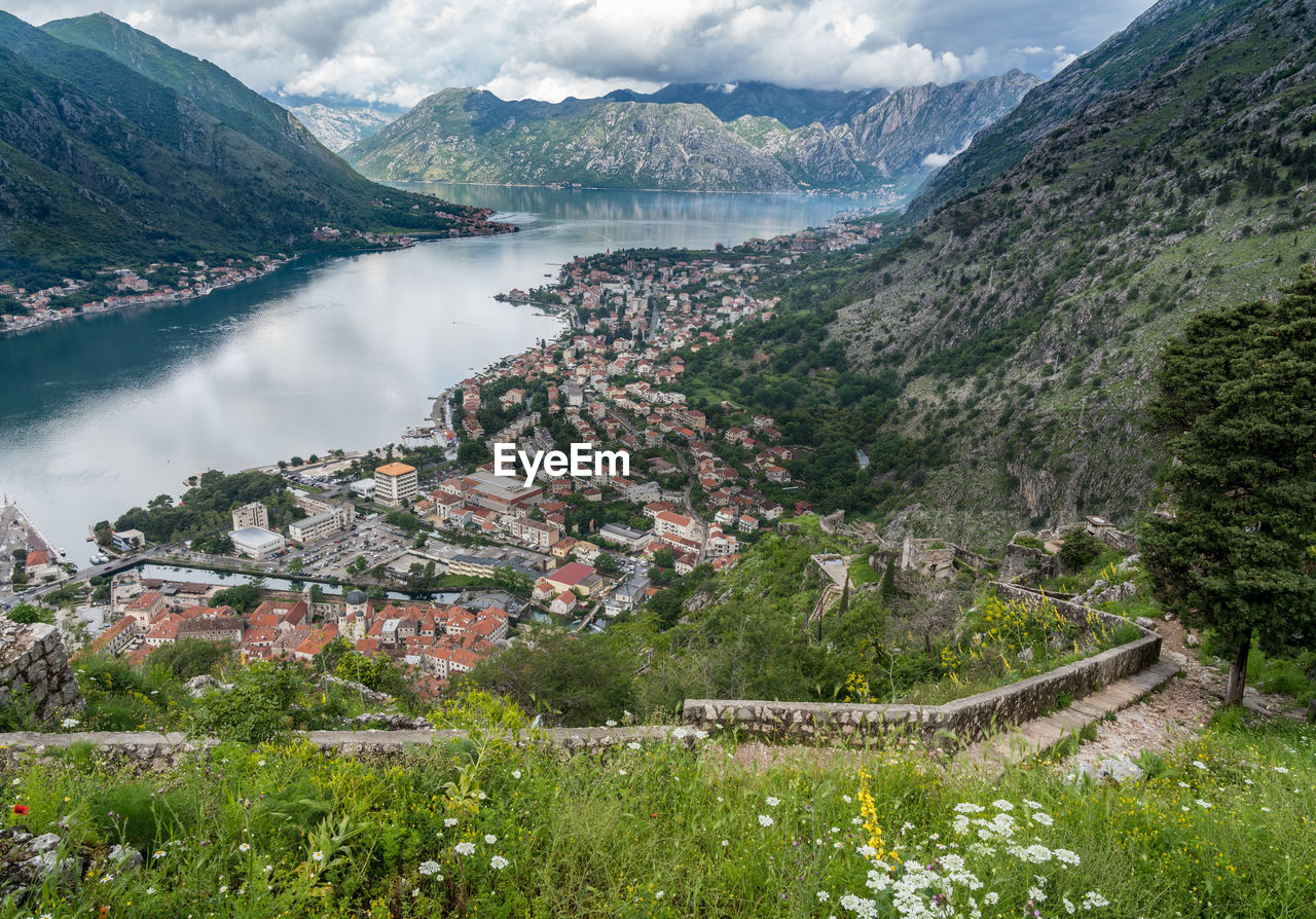 HIGH ANGLE VIEW OF BUILDINGS AND MOUNTAINS