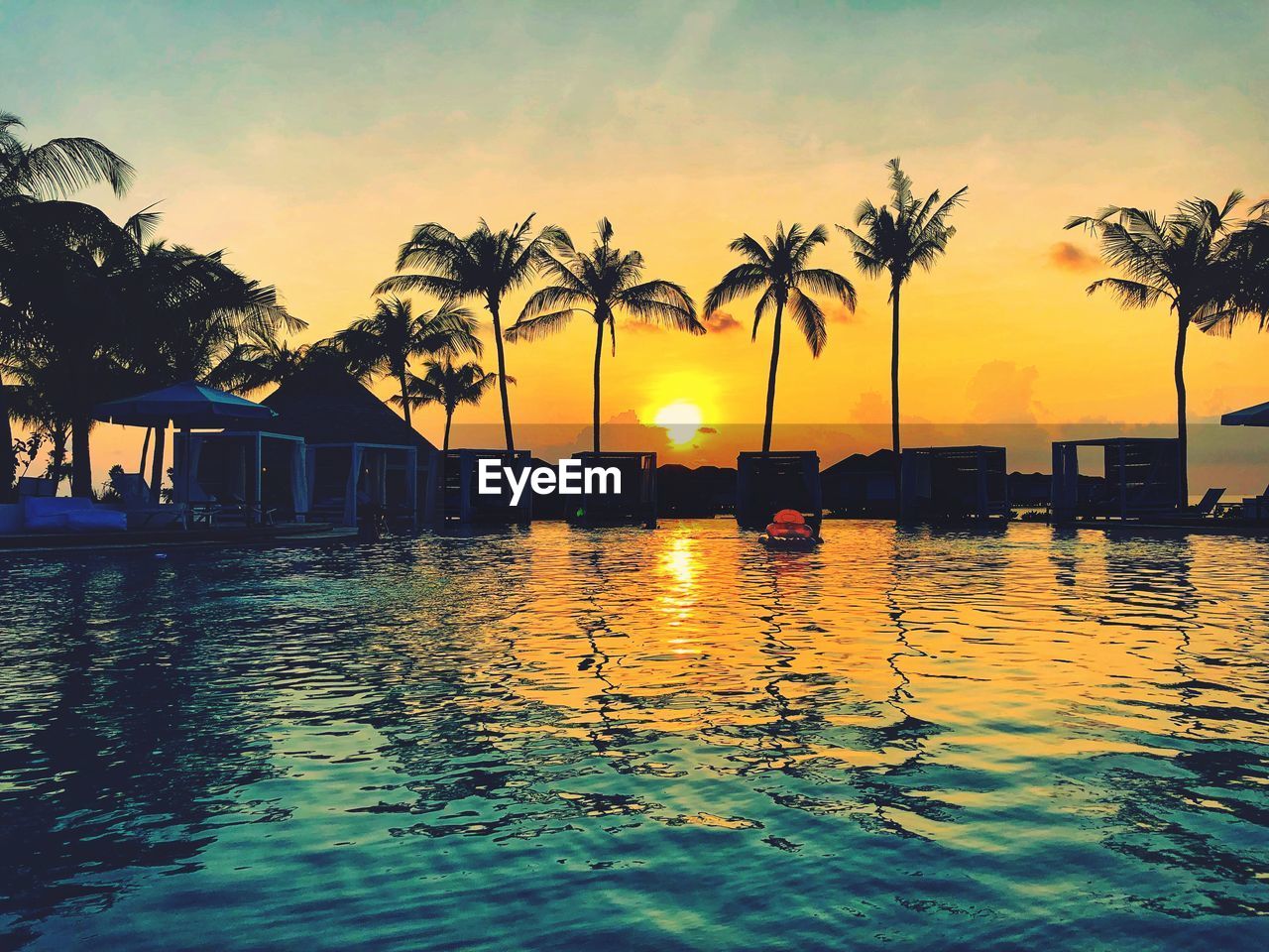 Scenic view of swimming pool against sky during sunset