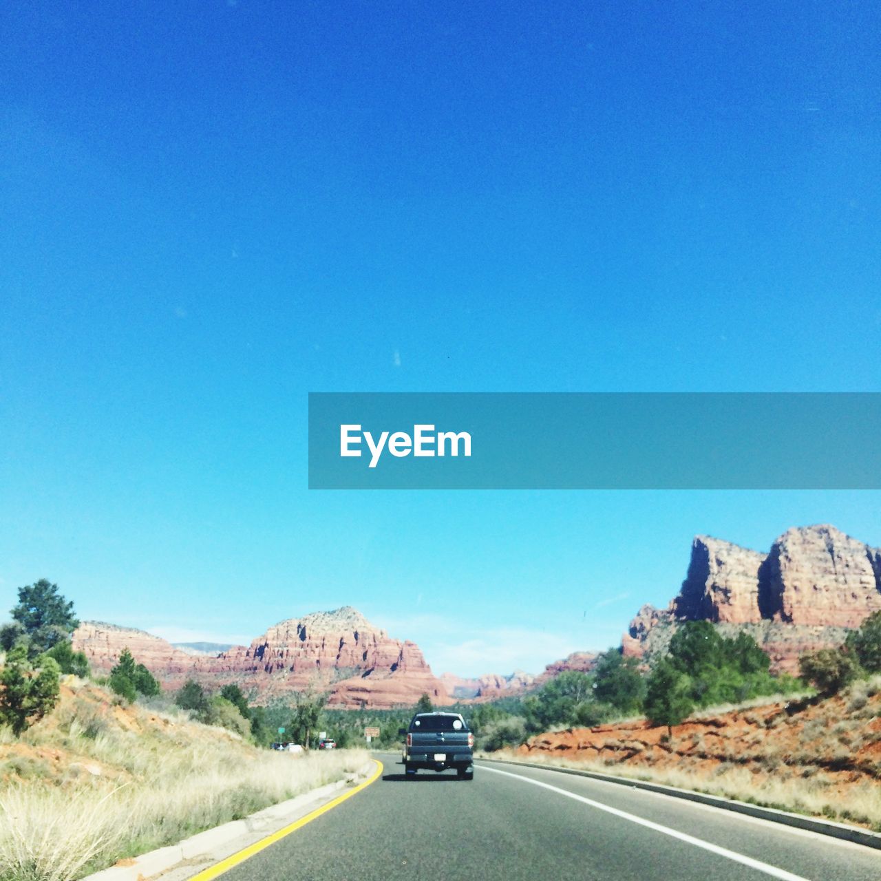 HIGHWAY AGAINST CLEAR BLUE SKY