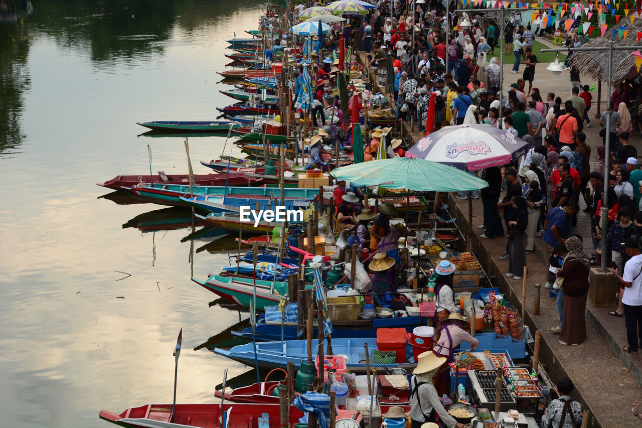 water, group of people, transportation, large group of people, crowd, nautical vessel, mode of transportation, high angle view, men, nature, market, boat, day, vehicle, adult, river, outdoors, women, umbrella, lifestyles, travel, boating, architecture, retail, city, protection, person, selling, tradition, multi colored, small business, travel destinations, business