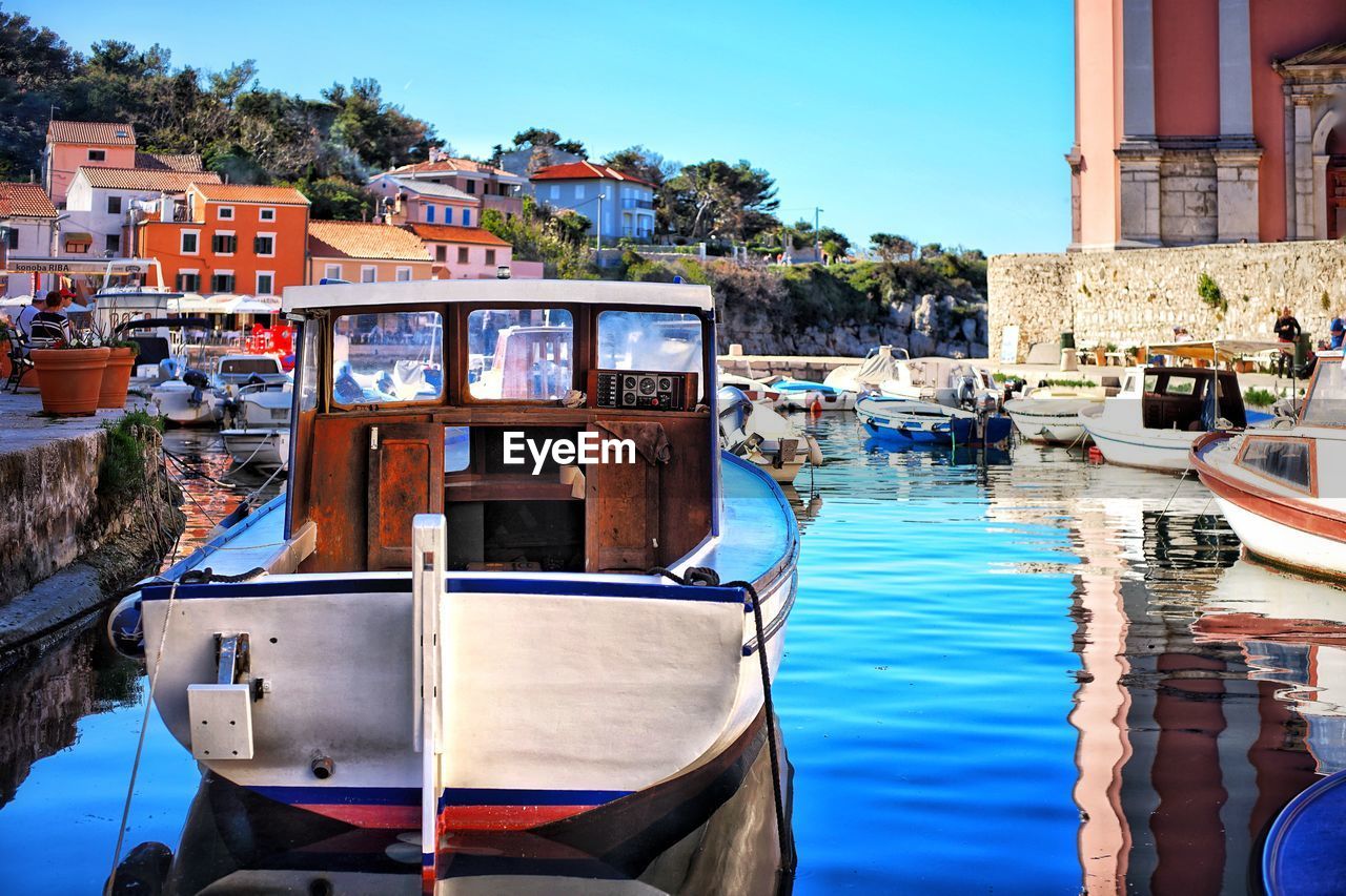 Boats in water against blue sky