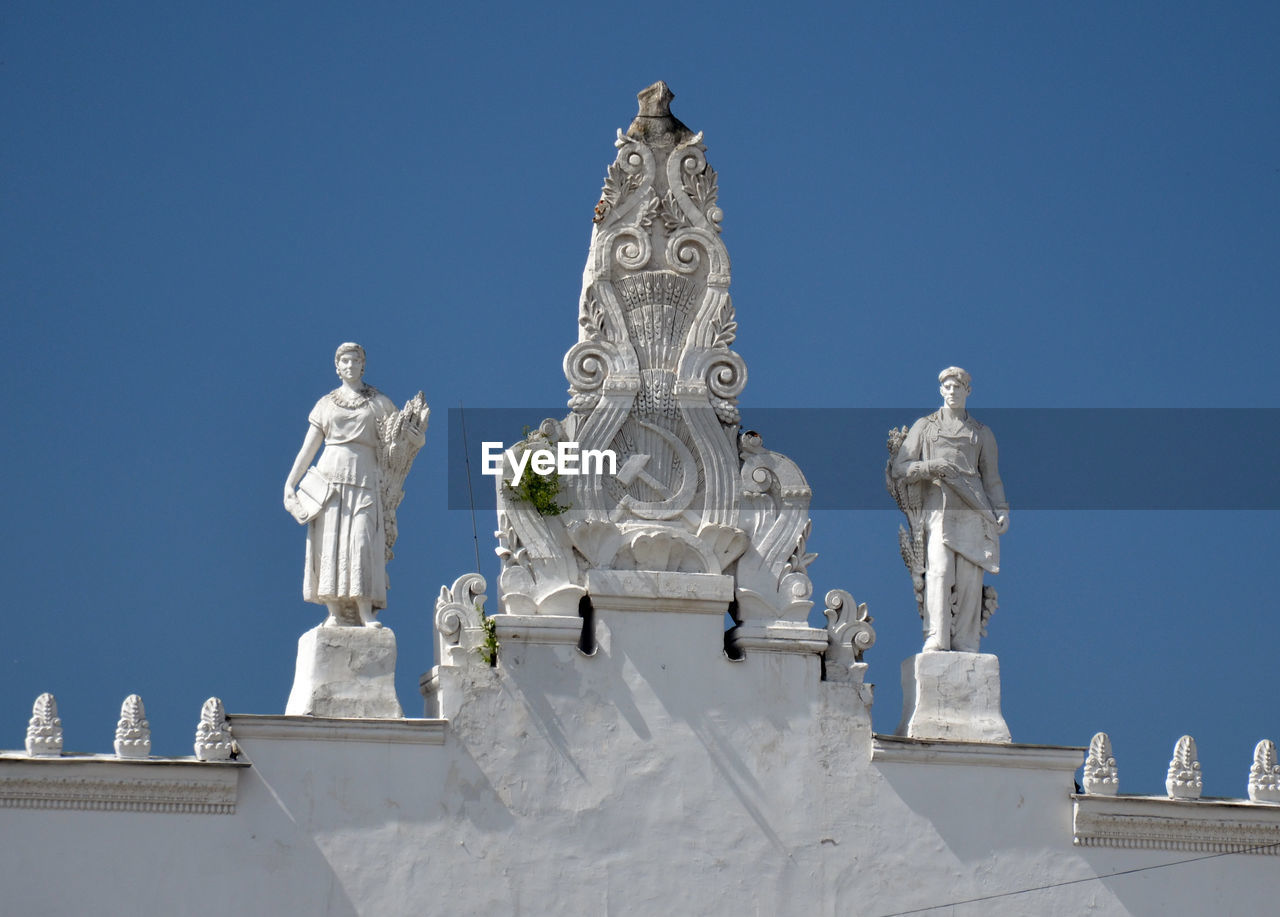 STATUES AGAINST SKY