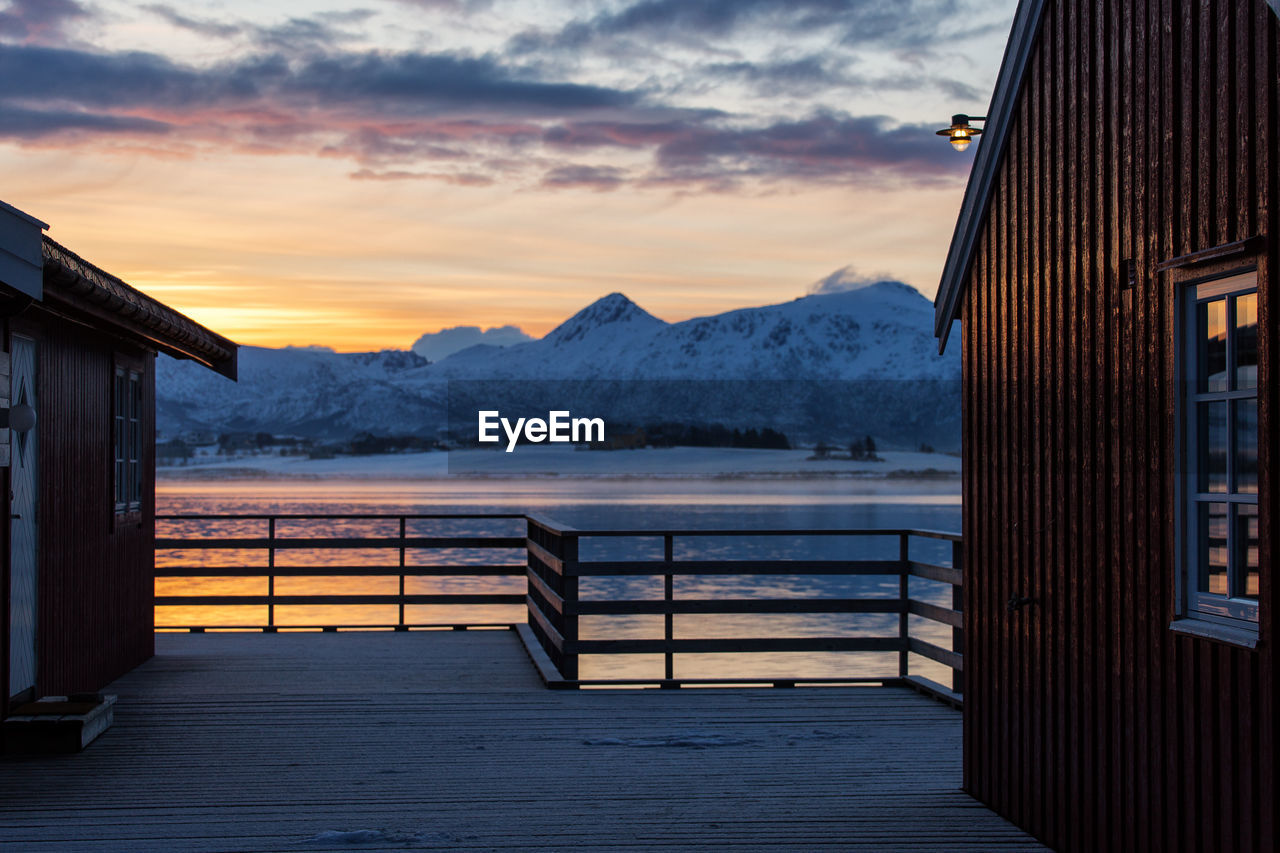 Scenic view of snowcapped mountains against sky during sunset