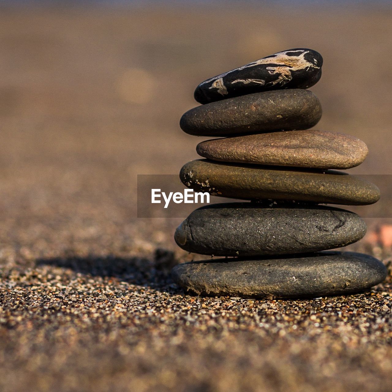CLOSE-UP OF STACK OF PEBBLES ON STONE